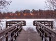 Lake of the Woods floating dock at spring ice-out with calm water and cottage