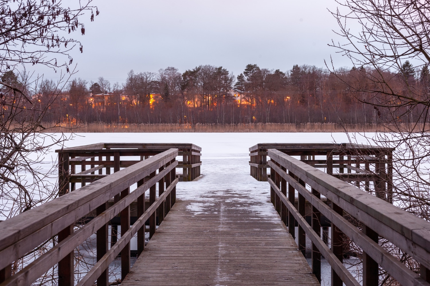 Lake of the Woods floating dock at spring ice-out with calm water and cottage Lake of the Woods floating dock at spring ice-out with calm water and cottage