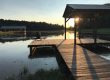 Organized cottage dock with storage bench overlooking Lake of the Woods at sunrise