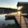 Organized cottage dock with storage bench overlooking Lake of the Woods at sunrise