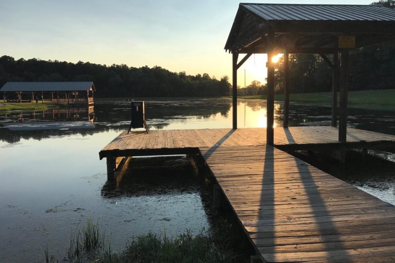 Organized cottage dock with storage bench overlooking Lake of the Woods at sunrise Organized cottage dock with storage bench overlooking Lake of the Woods at sunrise