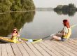 Family enjoying a multi-use floating dock on a Saskatchewan lake at sunset