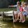 Family enjoying a beautiful Manitoba cottage waterfront with dock at sunset
